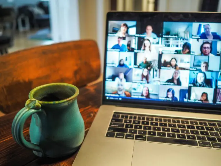 A laptop showing an online conference. Photo by Chris Montgomery via Unsplash.